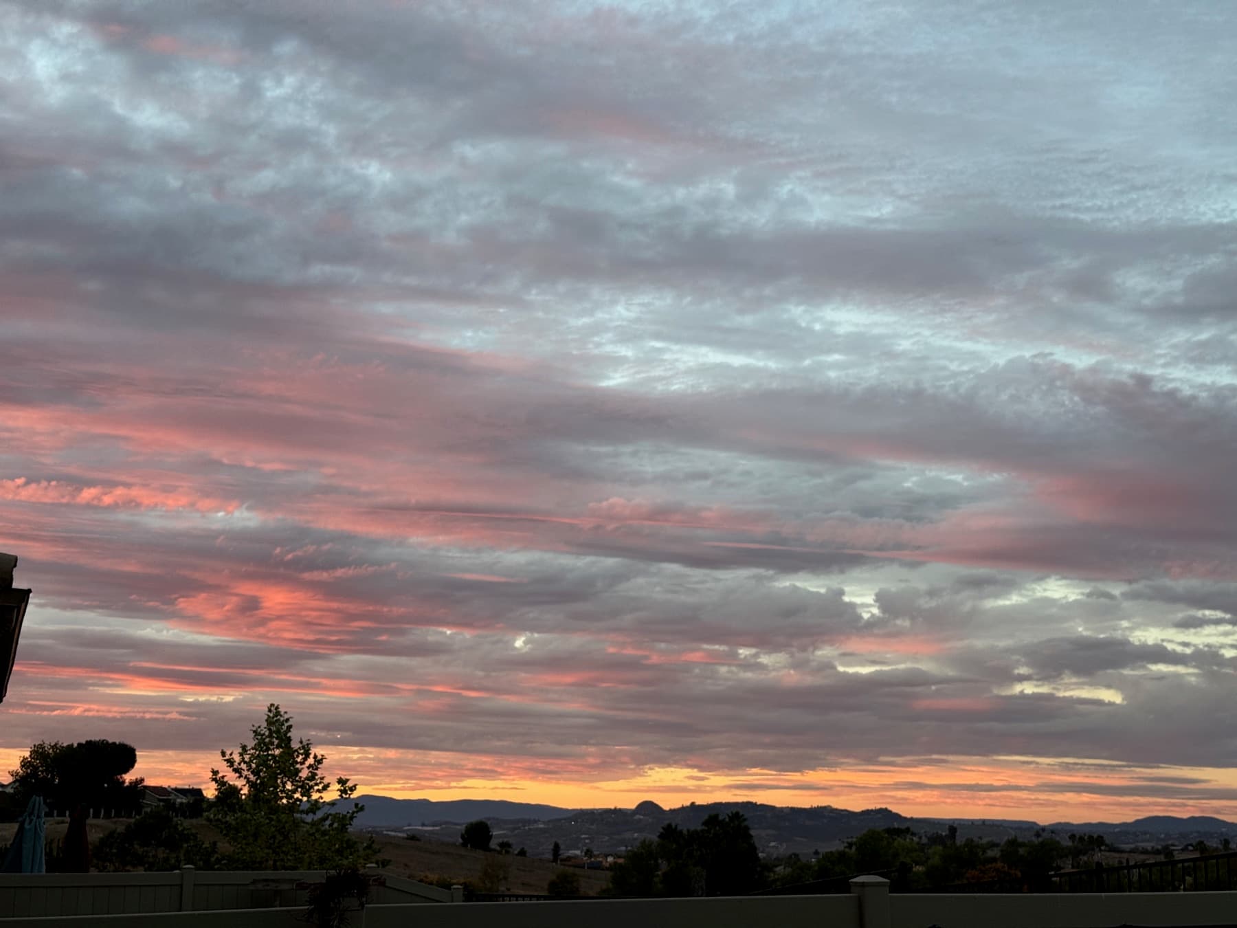 A pink and lavender sunset over low hills